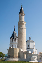 White Church and mosque on blue sky background.