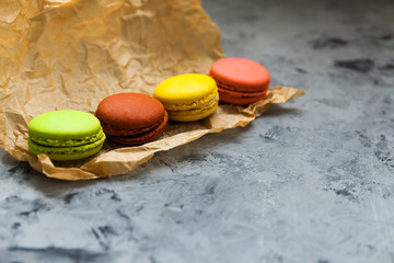 Beautiful variety of macaroons on gray background. Stylish arrangement sweet. Flat lay, top view.