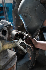 welder restoring a metal part in the workshop