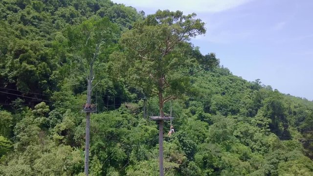 Aerial View of Tourists Riding on Zipline or Canopy Rope. Adrenaline Adventure on Vacation