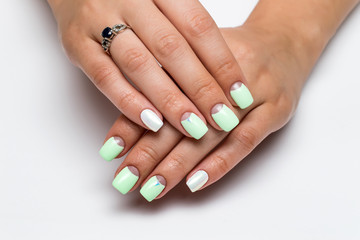 pastel mint moon manicure on square short nails with crystals on nameless fingers on a white background

