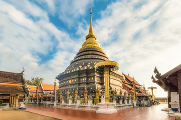 Buddhism temple lanna Golden Pagoda Phra That Lampang Luang blue sky cloudy, Lampang, Thailand - obrazy, fototapety, plakaty