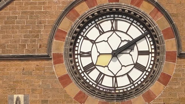 A static close up of a clock on a building