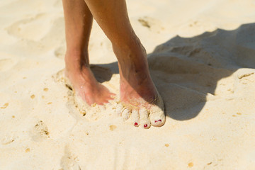 Beach travel - woman walking on sand beach