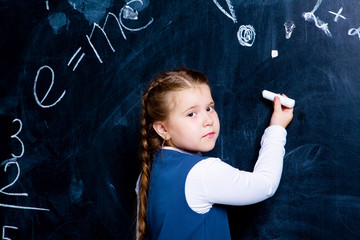  girl   at school against chalkboard