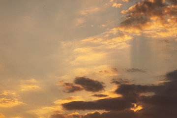Clouds in the rays of sunset as background