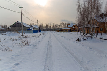 Fototapeta premium Road in the snow at sunset in winter