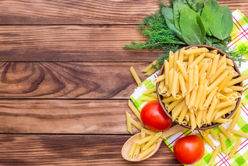 Raw pasta with ingredients for cooking. Top view with copy space.