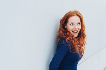 Young redhead woman with an excited expression