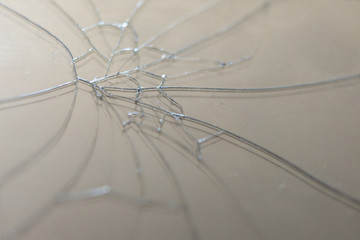 A broken screen of a mobile phone. Cracks on thin glass.