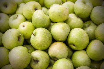 Fresh apples spread out an even layer as a background.