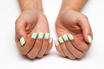 pastel mint moon manicure on square short nails with crystals on nameless fingers on a white background