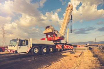Crane truck in the construction of a bridge on a highway © Enrique del Barrio