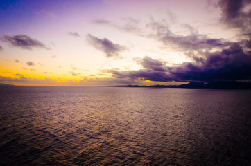 Fototapeta premium Blue orange sunset on empty peaceful quiet ocean water in pacific atlantic sea for ship cruise family vacation and holiday