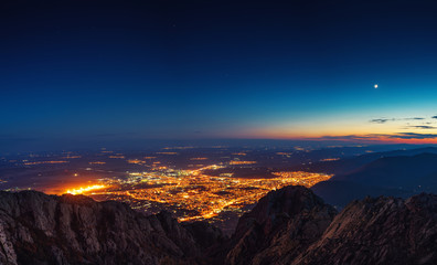 Sunset over the mountain hills and Sliven city, aerial panoramic view