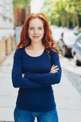 Confident slim young redhead woman
