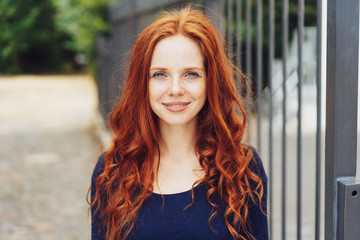 Pretty young woman with gorgeous curly red hair