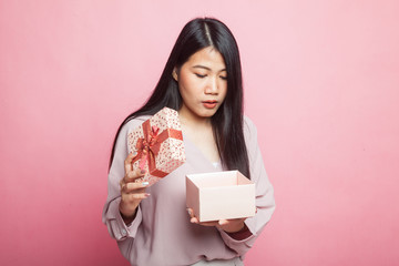 Young Asian woman open a gift box.