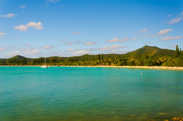 Empty abandoned quiet island with sea green bule water and cloudy sky with forest rock and trees for vacation holiday destination for cruise ship