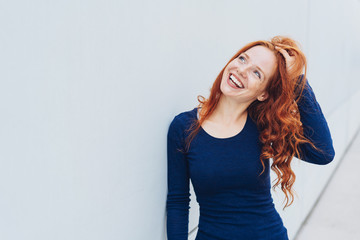 Attractive vivacious young redhead woman