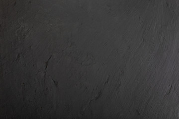Black slate texture in which the veins of the mineral can be seen.