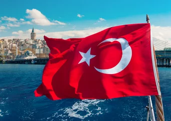 Poster Turkish flag waving on a boat and Galata Tower on the background in Istanbul © nexusseven