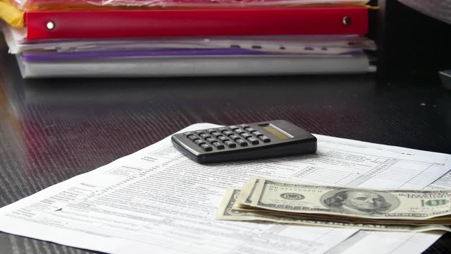 Money are falling on the table. US dollars dropping down