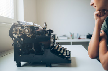 Female writer thinking on writer's desk