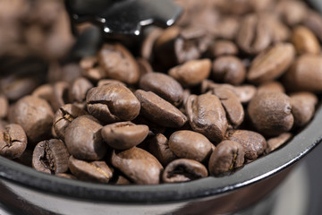 The fried coffee beans lie in a coffee grinder. Arab coffee is prayed in a mechanical coffee grinder. Morning coffee.