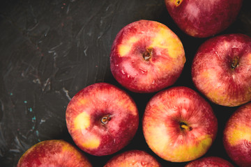 Fresh organic red apples on black background.