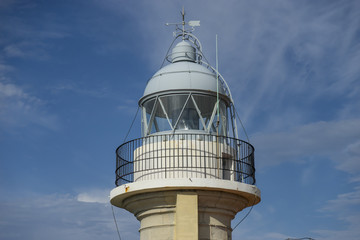 Fototapeta na wymiar Summer, coastal lighthouse on the Playa de los Locos in Cantabria, Spain