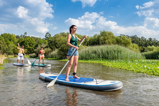 Man and women stand up paddleboarding