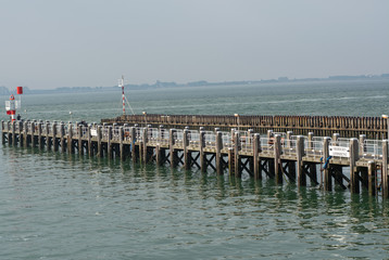 Fototapeta na wymiar Sea near Vlissingen, Zeeland, Netherlands, old wooden pier at high tide