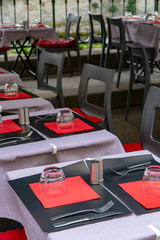 Empty cosy french street cafe or brasserie located on small river with served tables ready for visitors