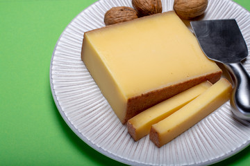 Piece of aged Comte or Gruyere de Comte, AOC French cheese made from unpasteurized cow's milk in the Franche-Comte region of eastern France with traditional methods of production.