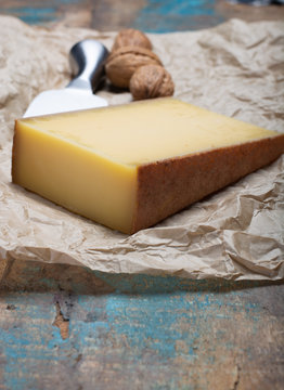 Piece of aged Comte or Gruyere de Comte, AOC French cheese made from unpasteurized cow's milk in the Franche-Comte region of eastern France with traditional methods of production.