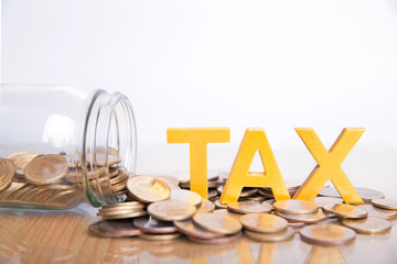 TAX Concept.Word tax put on coins and glass bottles with coins inside on white background.