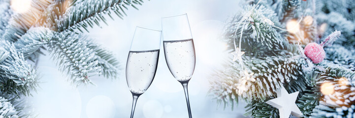 Decorated fir branches in winter with champagne glasses