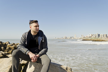 young man walking on the beach on a sunny day