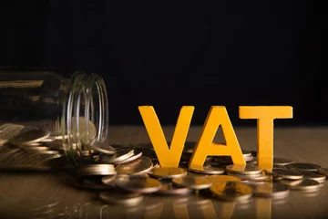 Fotobehang Vat Concept.Word vat put on coins and glass bottles with coins inside on black background. © Pcess609