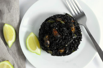 Traditional arroz negro - arr&ograve;s negre - black rice dish, typical for Valencia