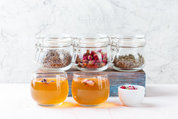 Dried rose flower buds and flowers in glass jars. Herbal tea, cleansing, organic bio products