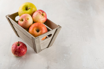 Decorative wooden box with red and green ripe apples