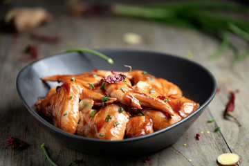 Raw Marinated chicken wings for BBQ, with green onion and dry red pepper