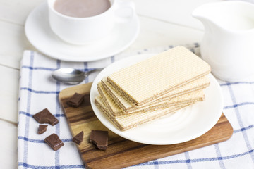 Chocolate Waffle bars on a white plate with cup of cocoa