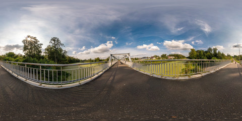 full seamless spherical panorama 360 by 180 angle view near iron steel frame construction of pedestrian bridge across the river in equirectangular projection, ready VR virtual reality content