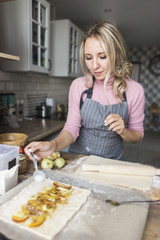 happy woman, mother is preparing a pie in the kitchen at home. concept of happy family and home coziness