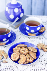 Tea time on rustic table with chocolate poppy seed cookies