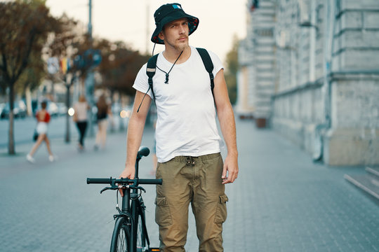 A man riding a bike in an old European city outdoors