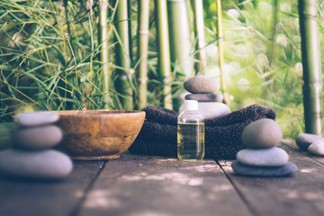 Spa concept with stones, massage oil and bamboo.  Japanese style. Simplicity, Zen, relax, calm and peaceful mood. Copy space